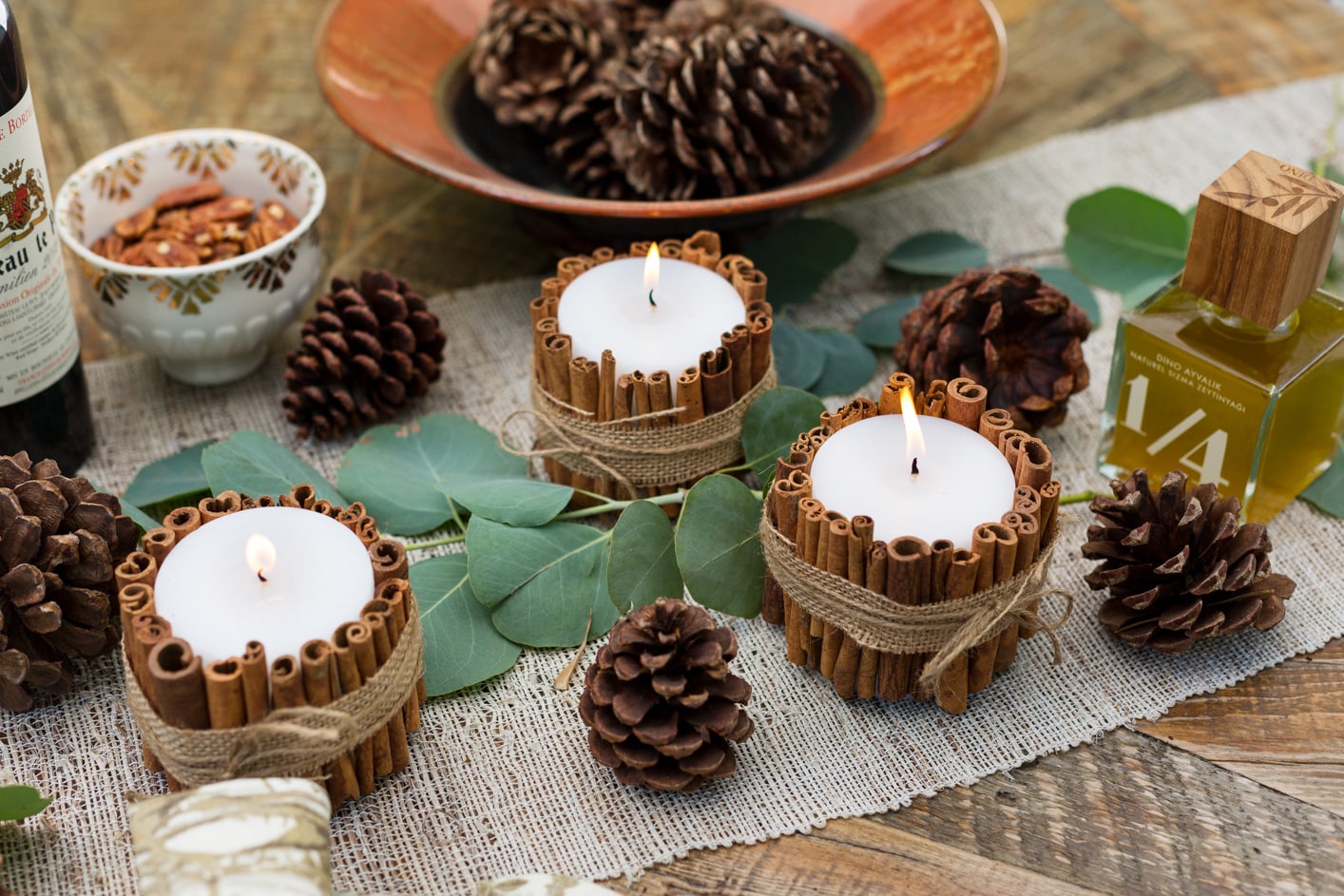 wine bottle with cinnamon sticks and candle fall