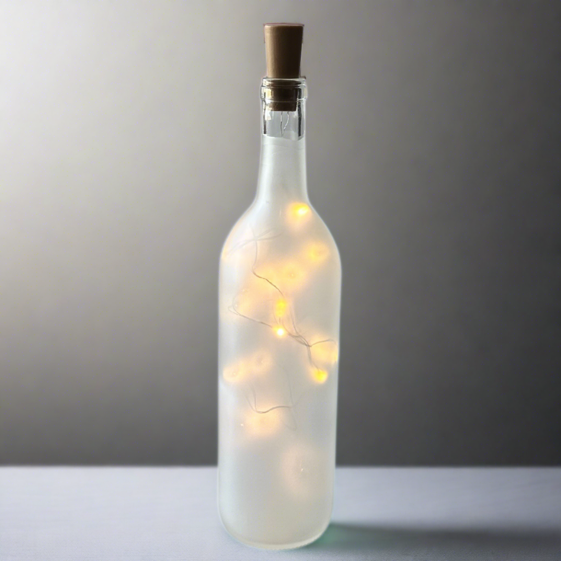 frosted wine bottle with string lights fall