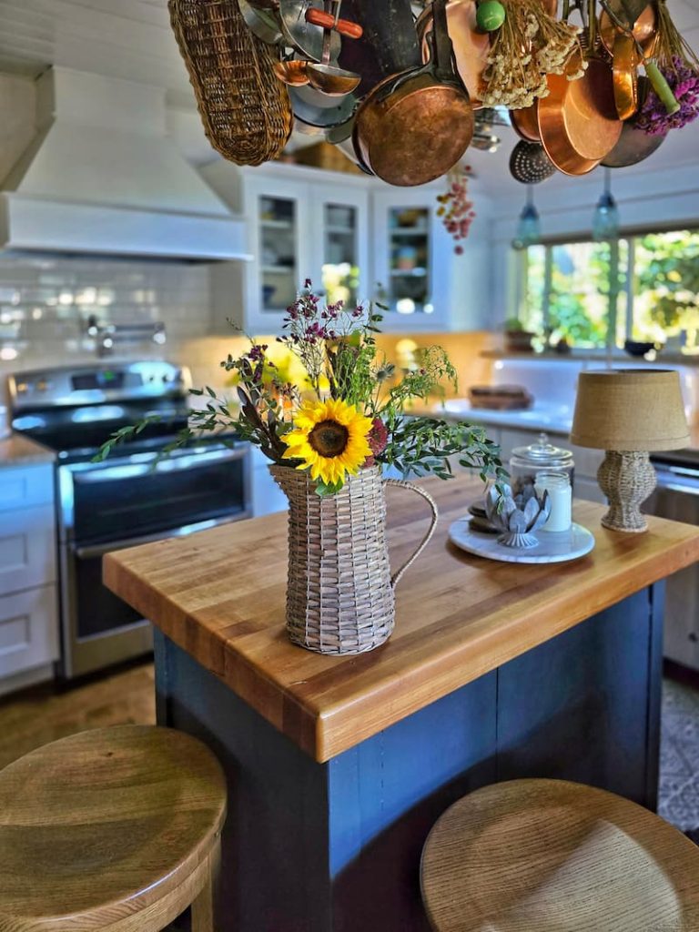 cozy fall kitchen with pumpkins candles and plaid runner
