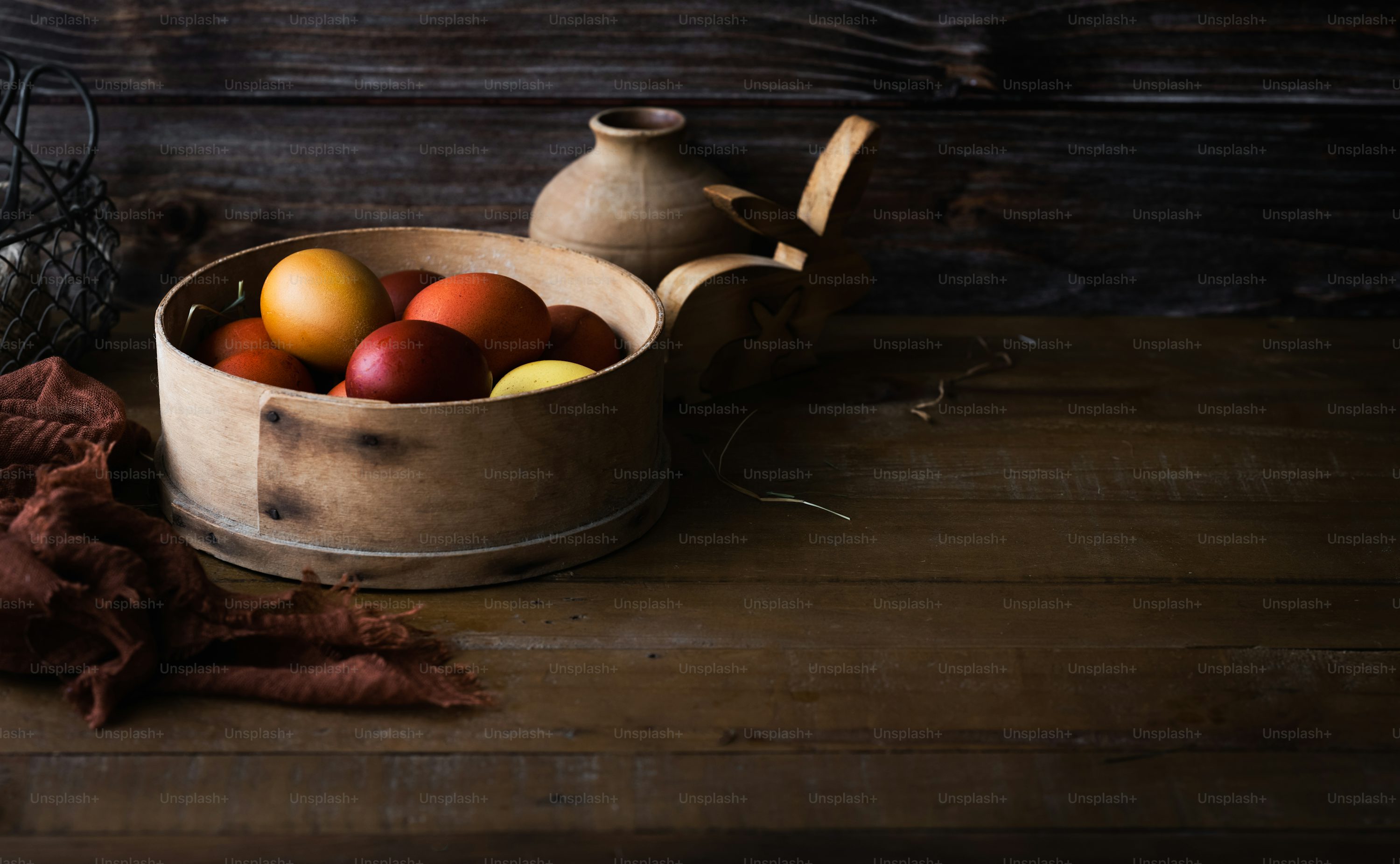 wooden bowl filled with apples and pears on kitchen table