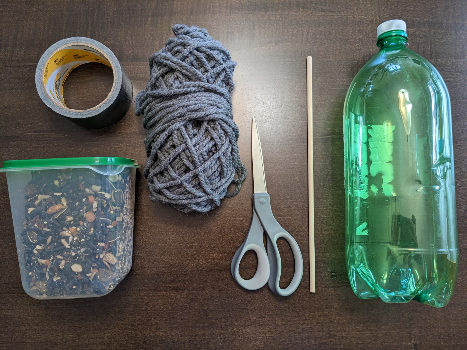 plastic bottle bird feeder hanging on rope