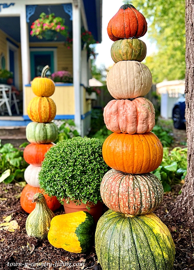 stacked pumpkin towers on porch