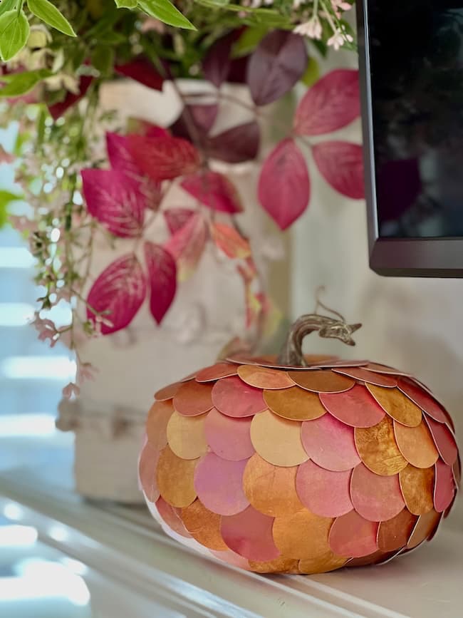 metallic painted pumpkins on mantel