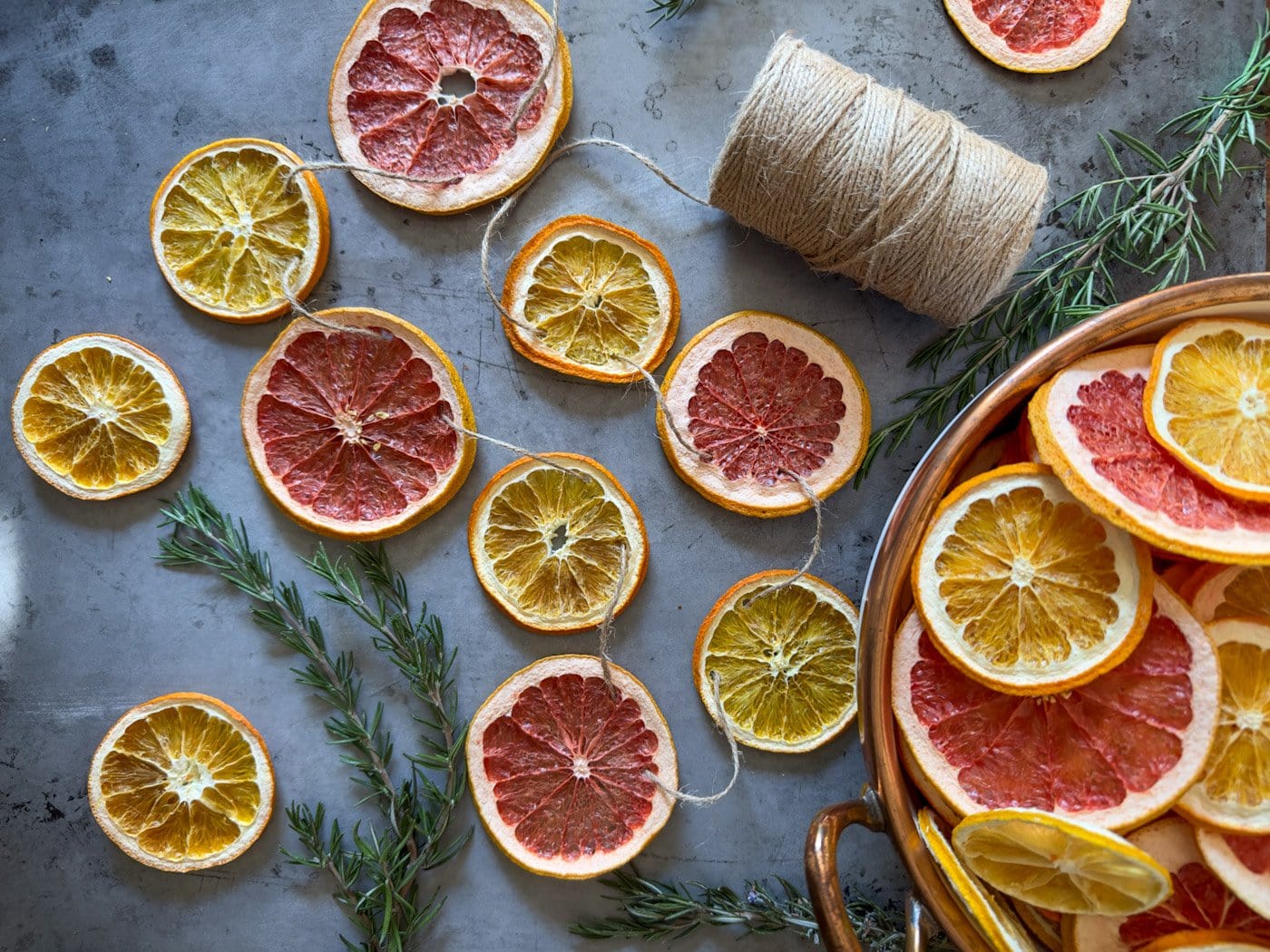 dried orange garland wrapped on wooden banister