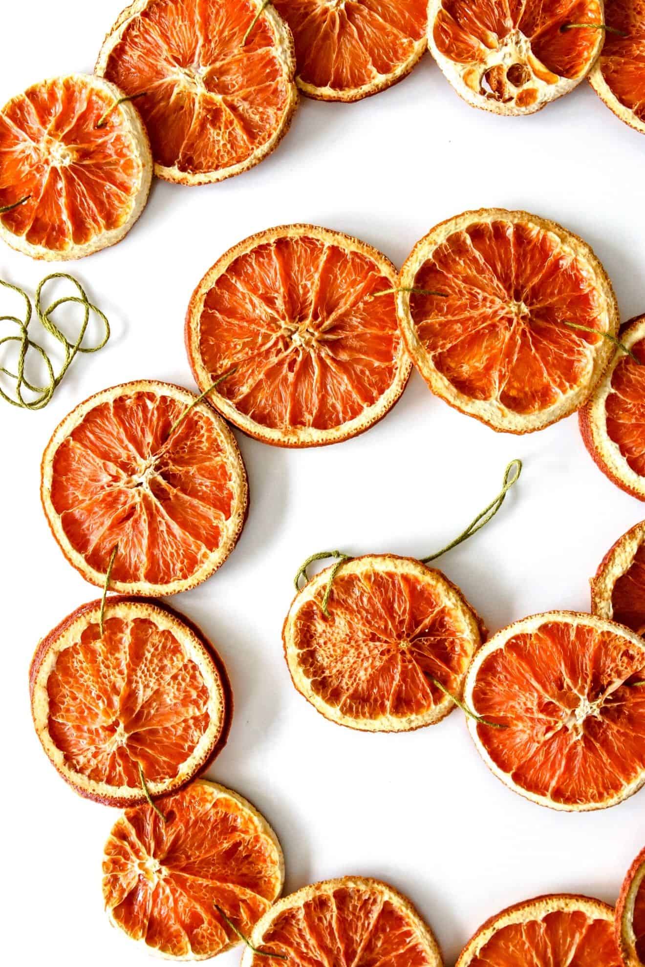 dried orange garland around wall mirror