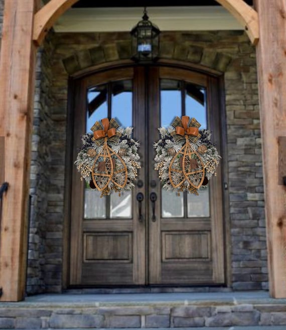 fall pinecone wreath on wooden front door