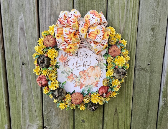 pinecone wreath with small pumpkins