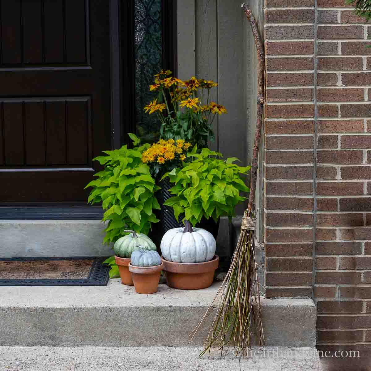 witch brooms leaning on halloween porch