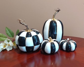 striped black and white pumpkins on mantel