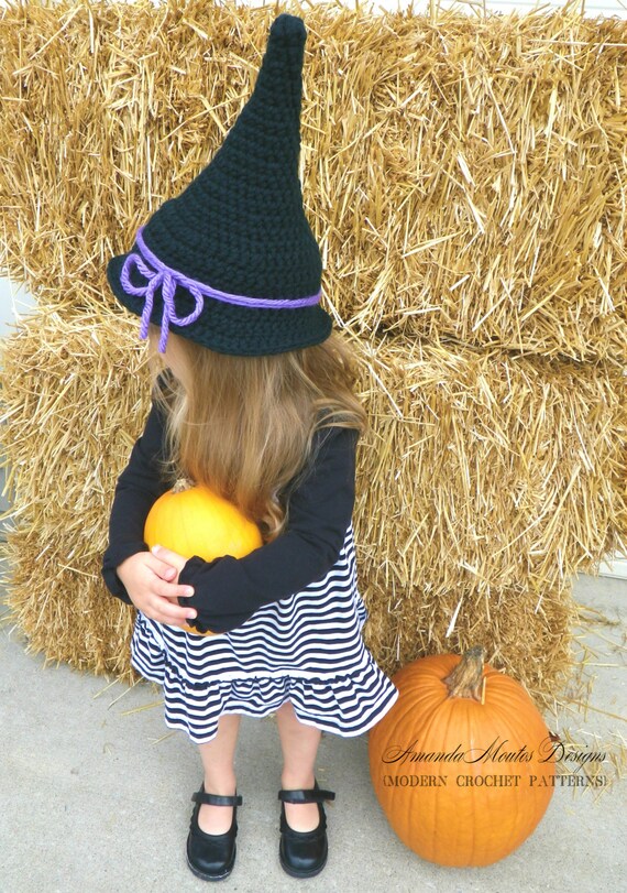 black and white striped witch hats on stand