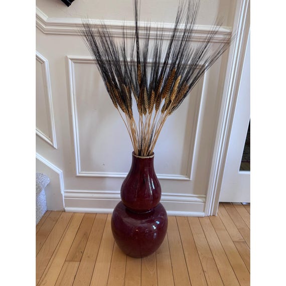 tall gourd vase with dried wheat stems