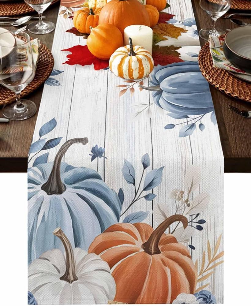 autumn table runner with pumpkins on wood table