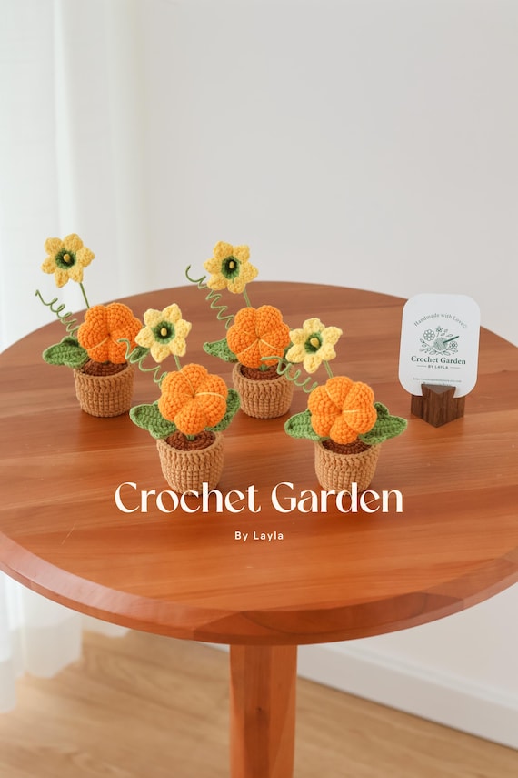 handmade crochet pumpkin on wooden table