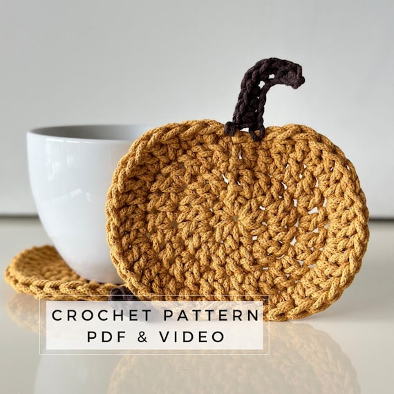 crochet pumpkin coasters on side table