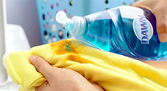 dish soap applied to grease stain on shirt