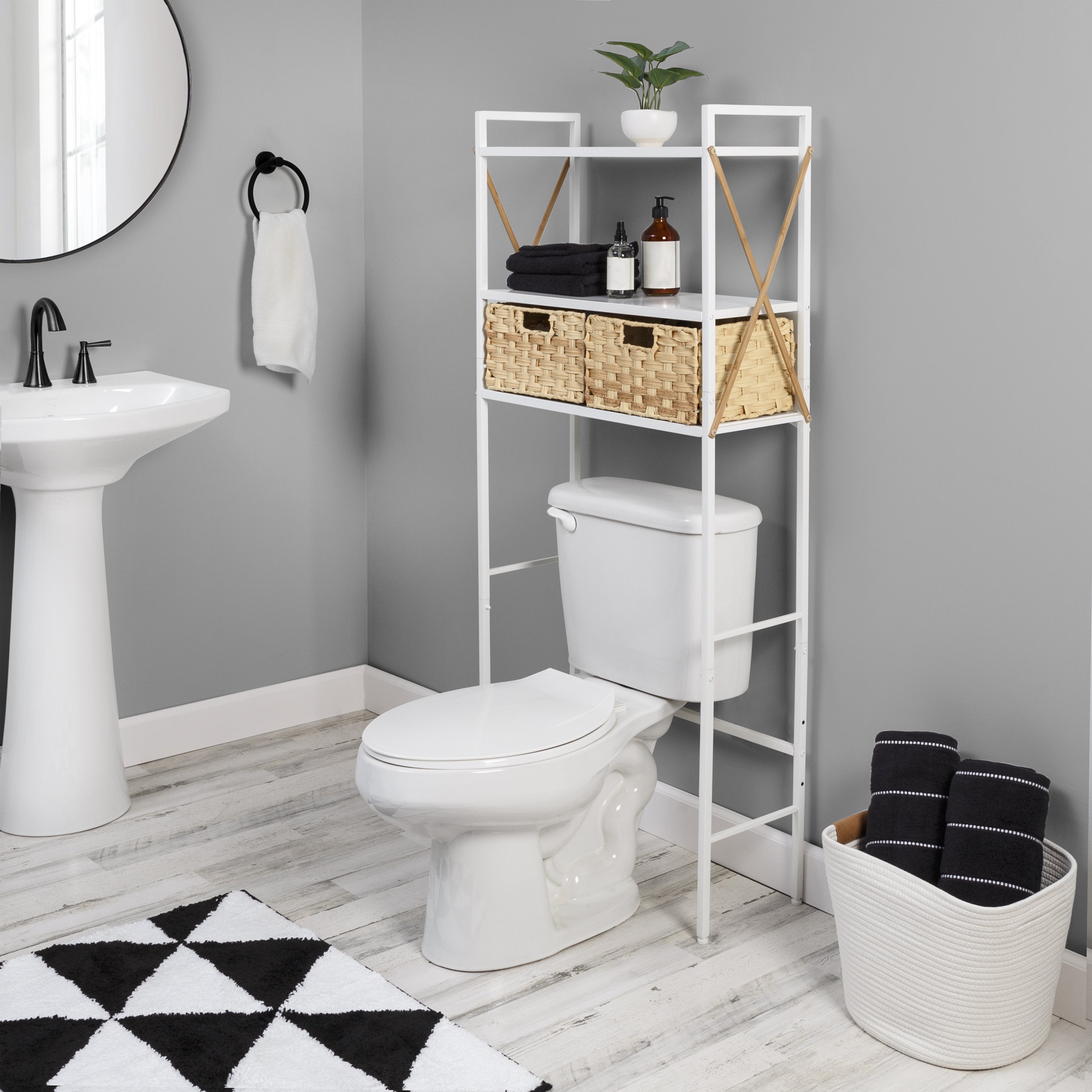 small bathroom with over toilet shelf and woven baskets