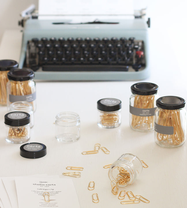 glass jars with pens and paper clips