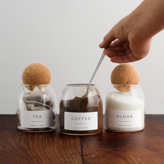 glass jars holding tea bags and sugar
