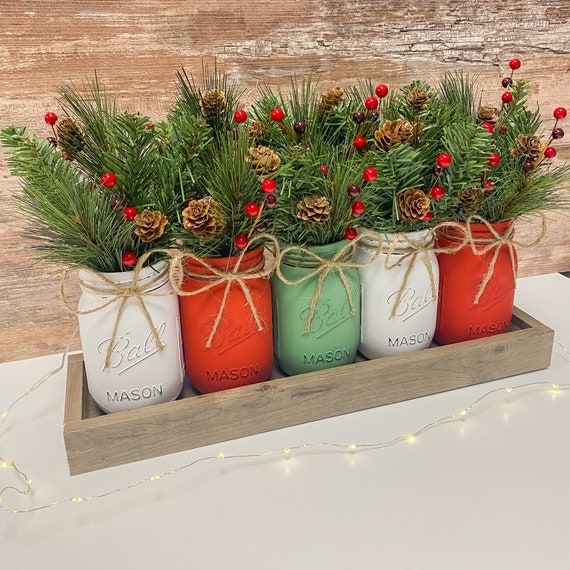mason jar with red berries and greenery