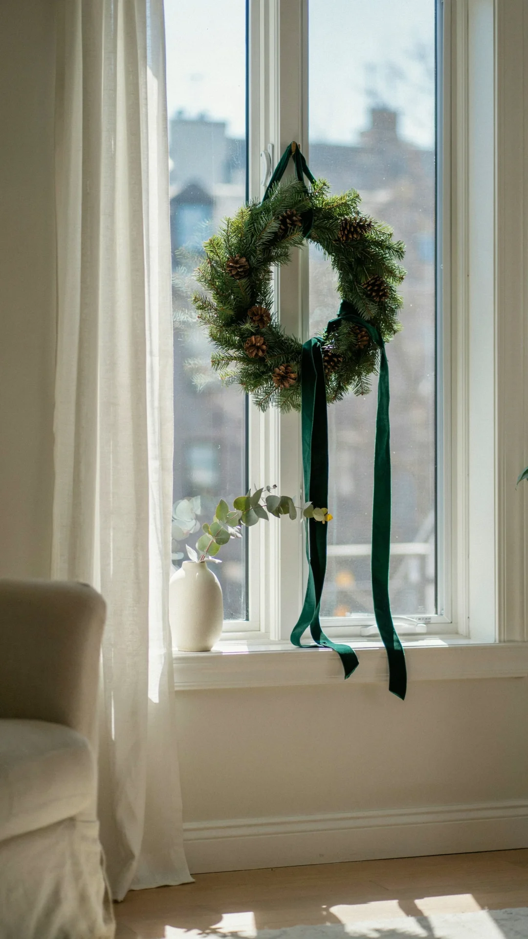 evergreen garland on window sill scandinavian living room