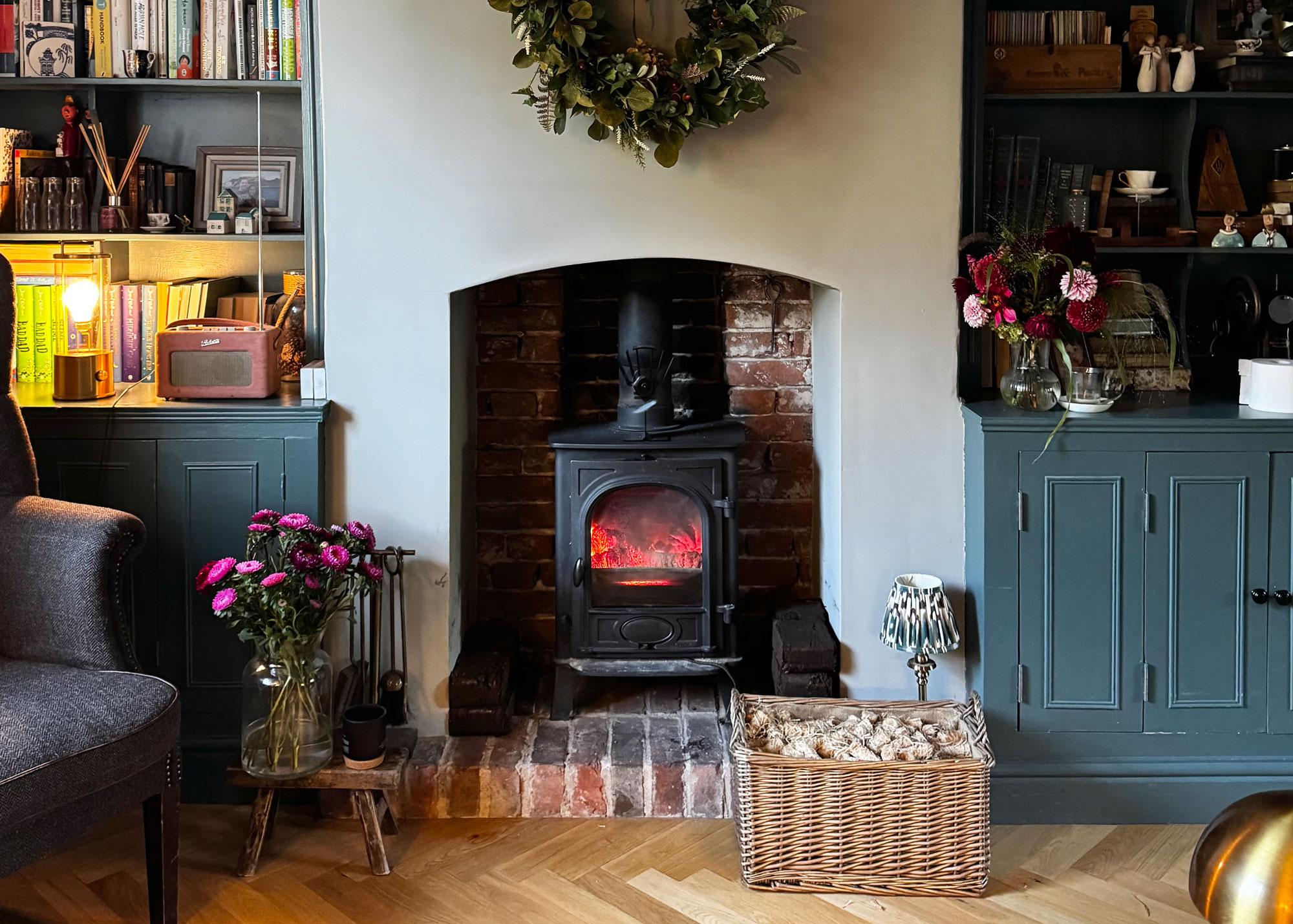 log basket beside fireplace scandinavian living room