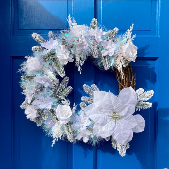 snowy white winter wreath on door