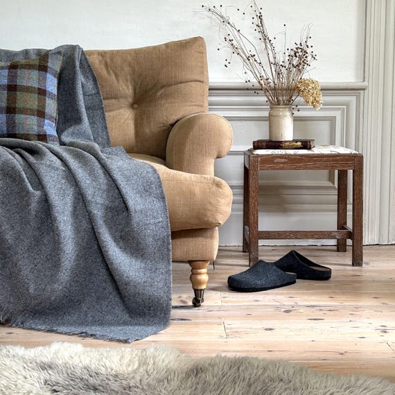 wool throw blanket draped over armchair