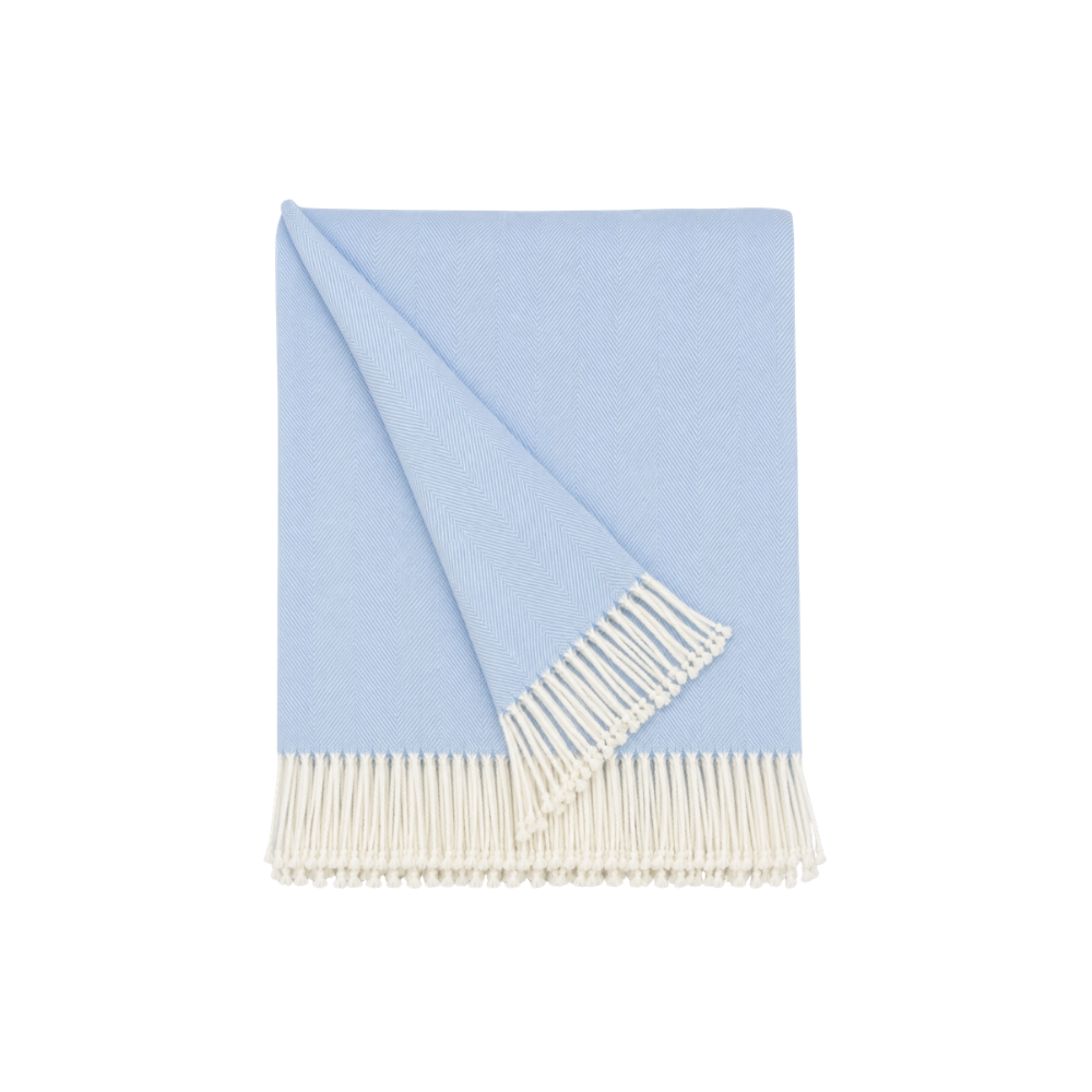 cashmere throw blanket folded on ottoman