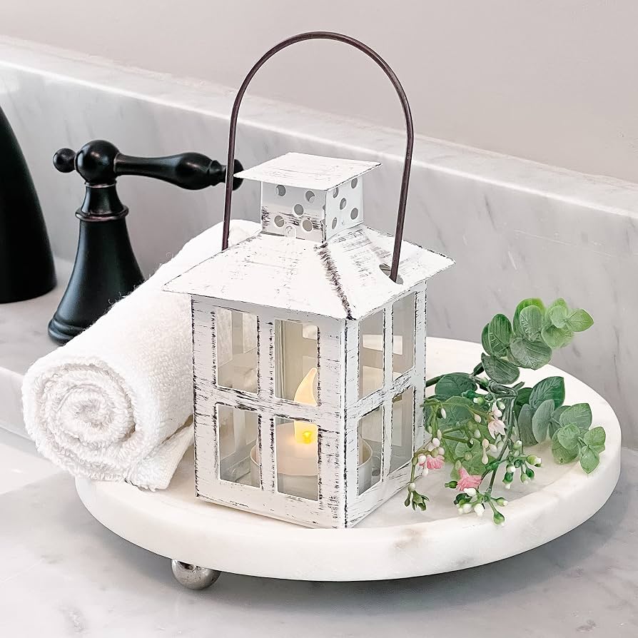 white candles and lanterns on shelf