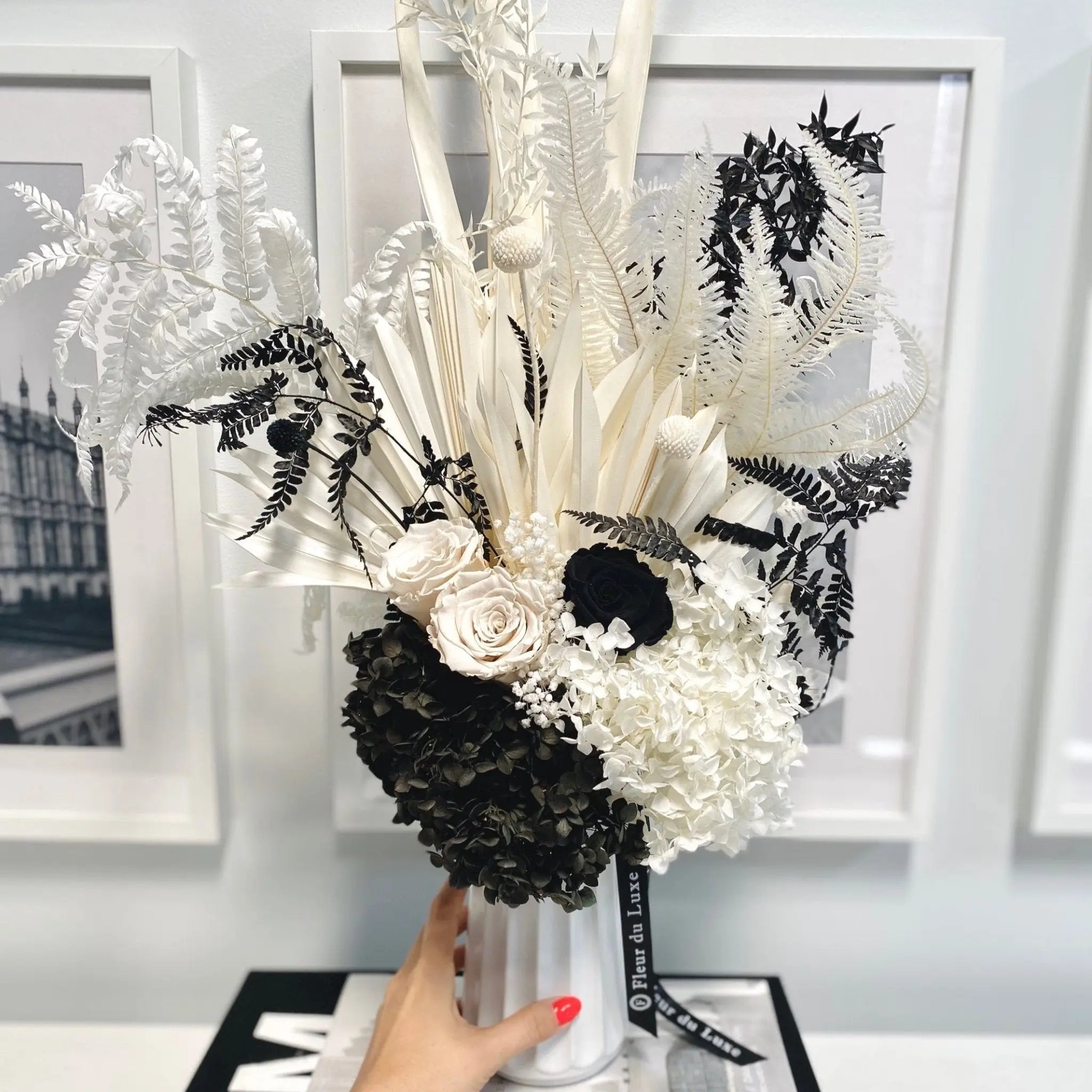 dried white flowers in vase on shelf