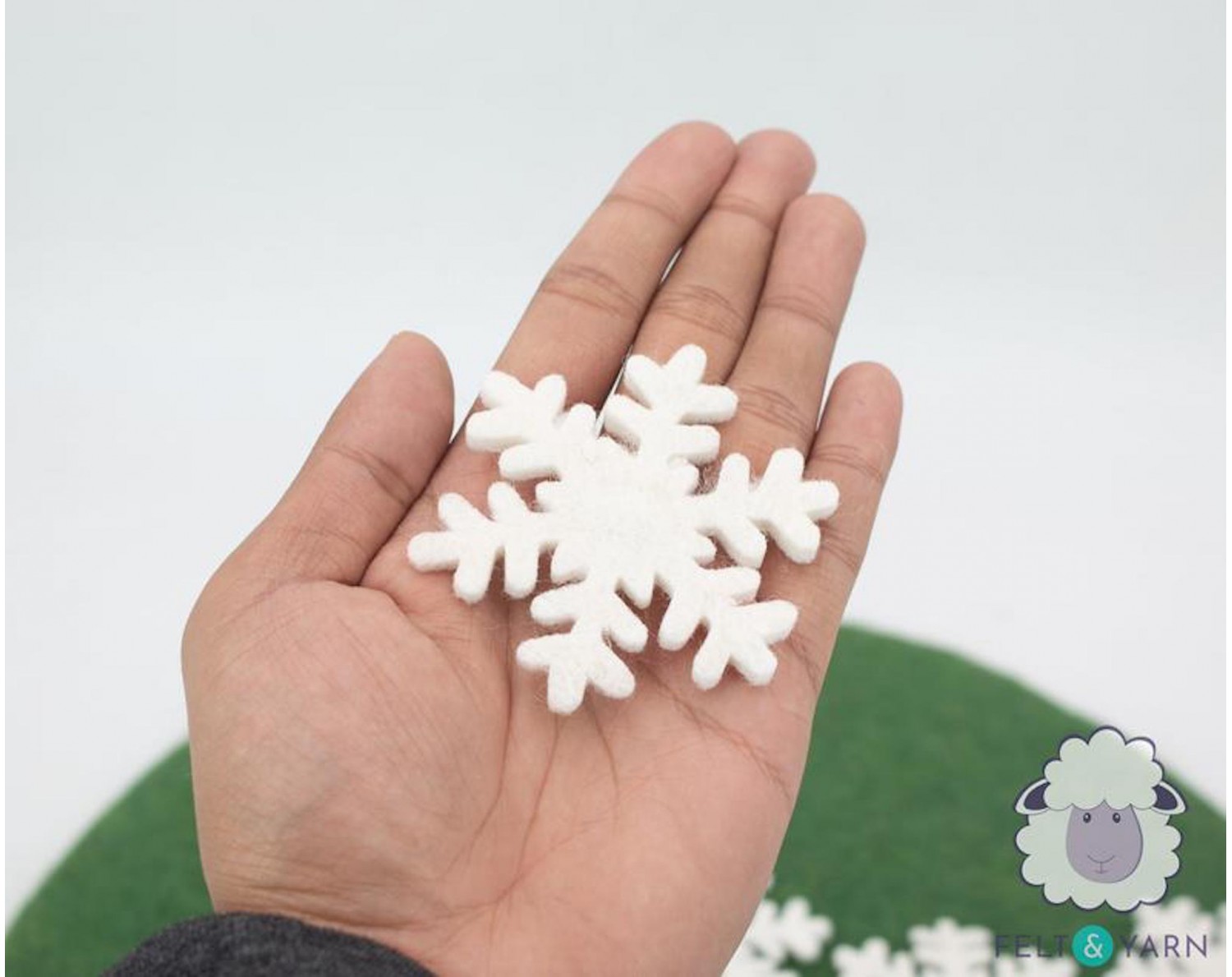 large felt snowflake ornament on wreath