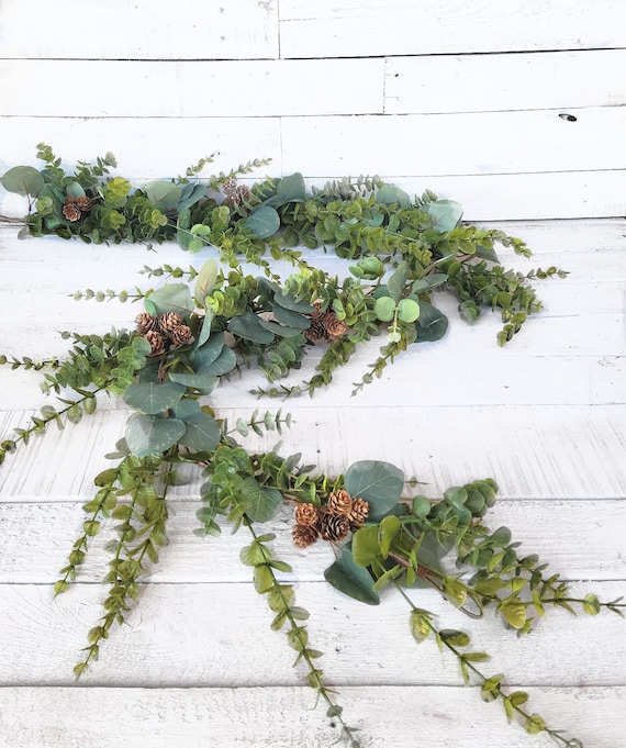 rustic pinecone garland draped over mantel