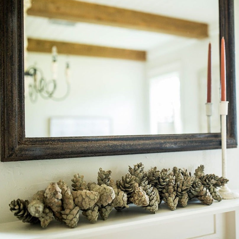 pinecone garland around mirror frame