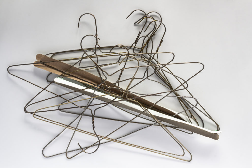 wire and plastic hangers pile
