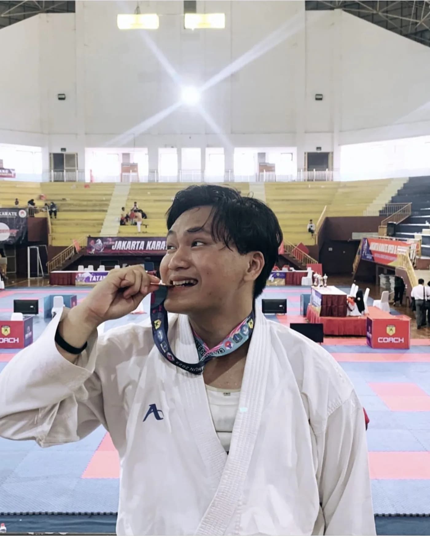 Arrow biting his medal at the Jakarta Karate Open Festival, 2023