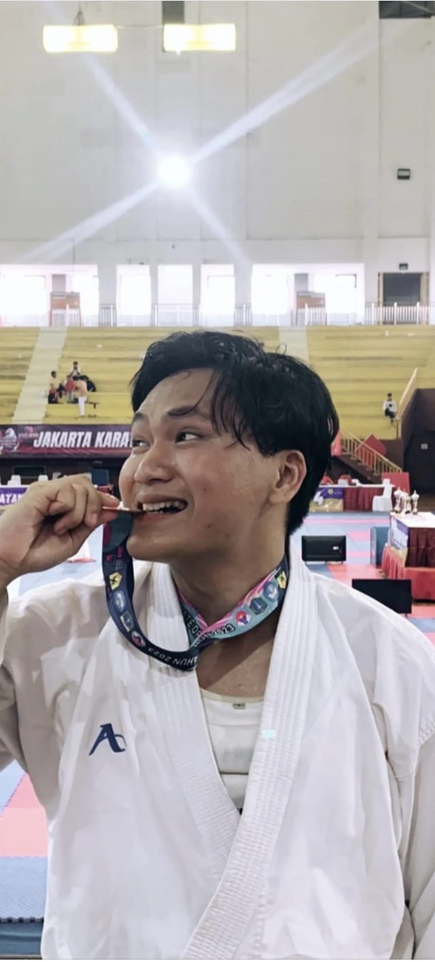 Arrow biting his karate medal