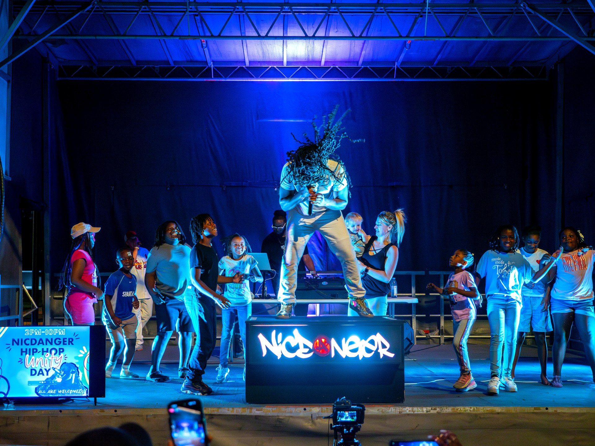 NicDanger on stage with kids dancing at Hip-Hop Unity Day