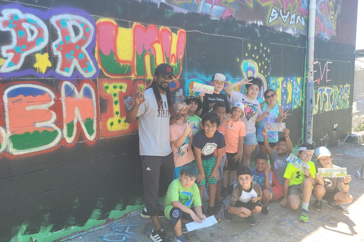TIM summer camp group at the graffiti wall