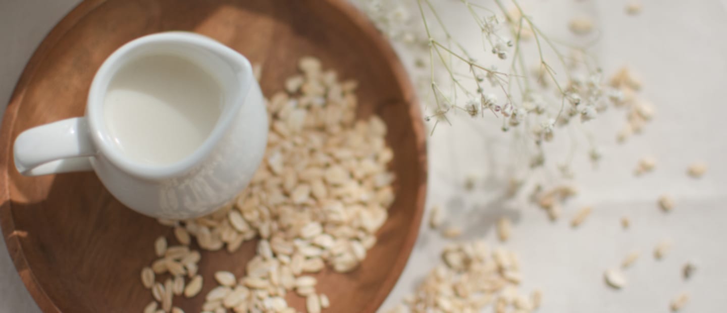 mleko krowie w kubeczku na stole z ozdobami