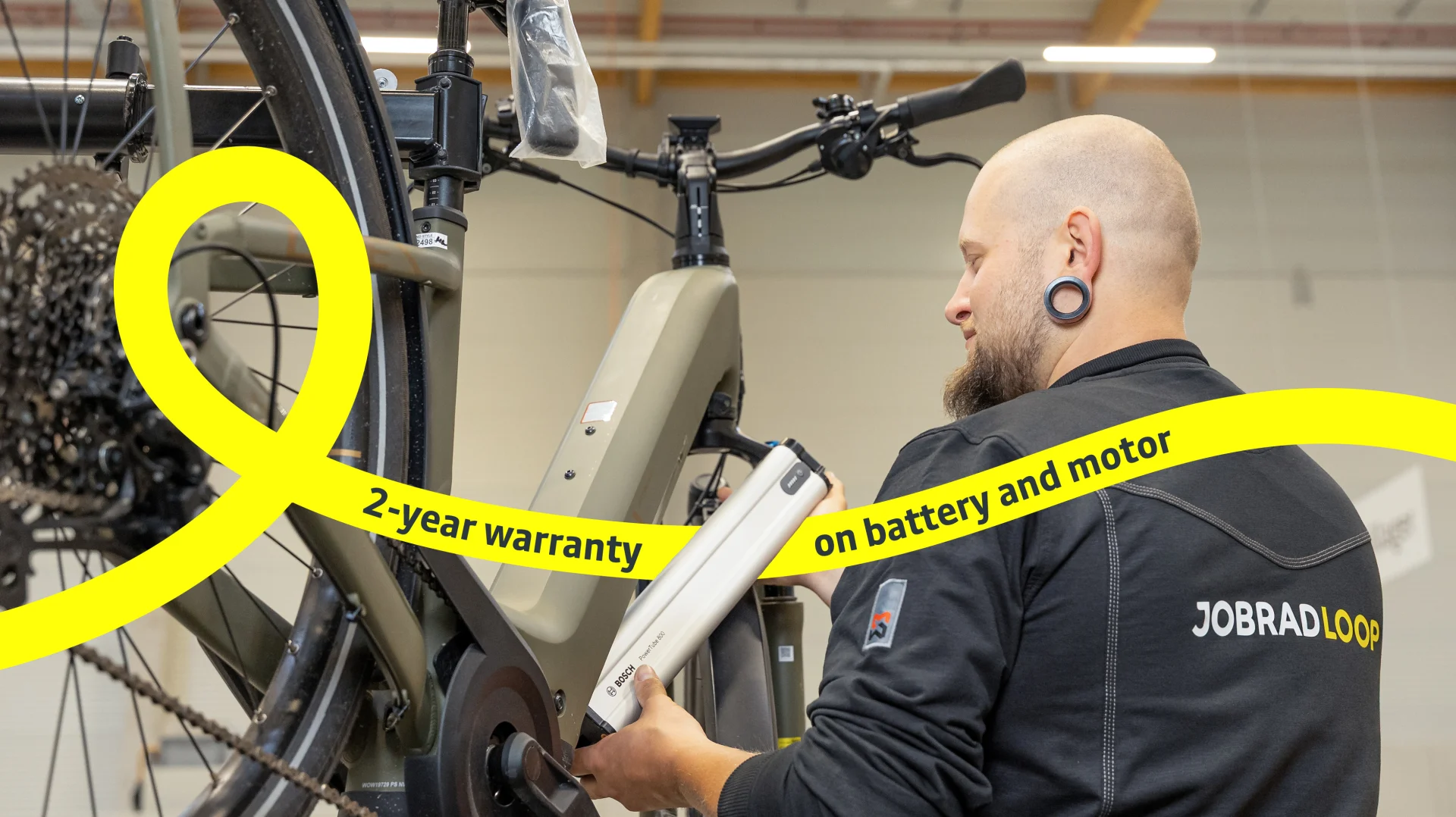 Mechanic changes battery on an e-bike.