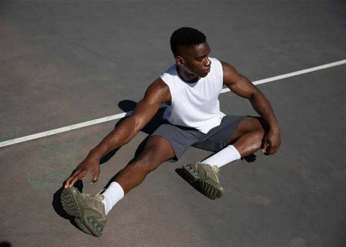 Male model wearing russell athletic white muscle tank