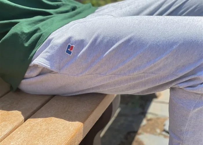 close up male model wearing gray russell athletic joggers