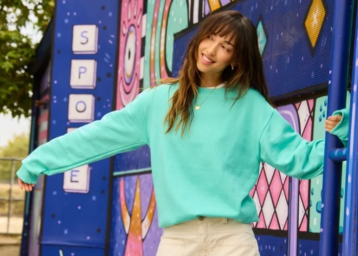 Female model wearing teal jerzee crewneck