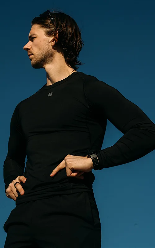 Male model wearing black compression long sleeve russell athletic top