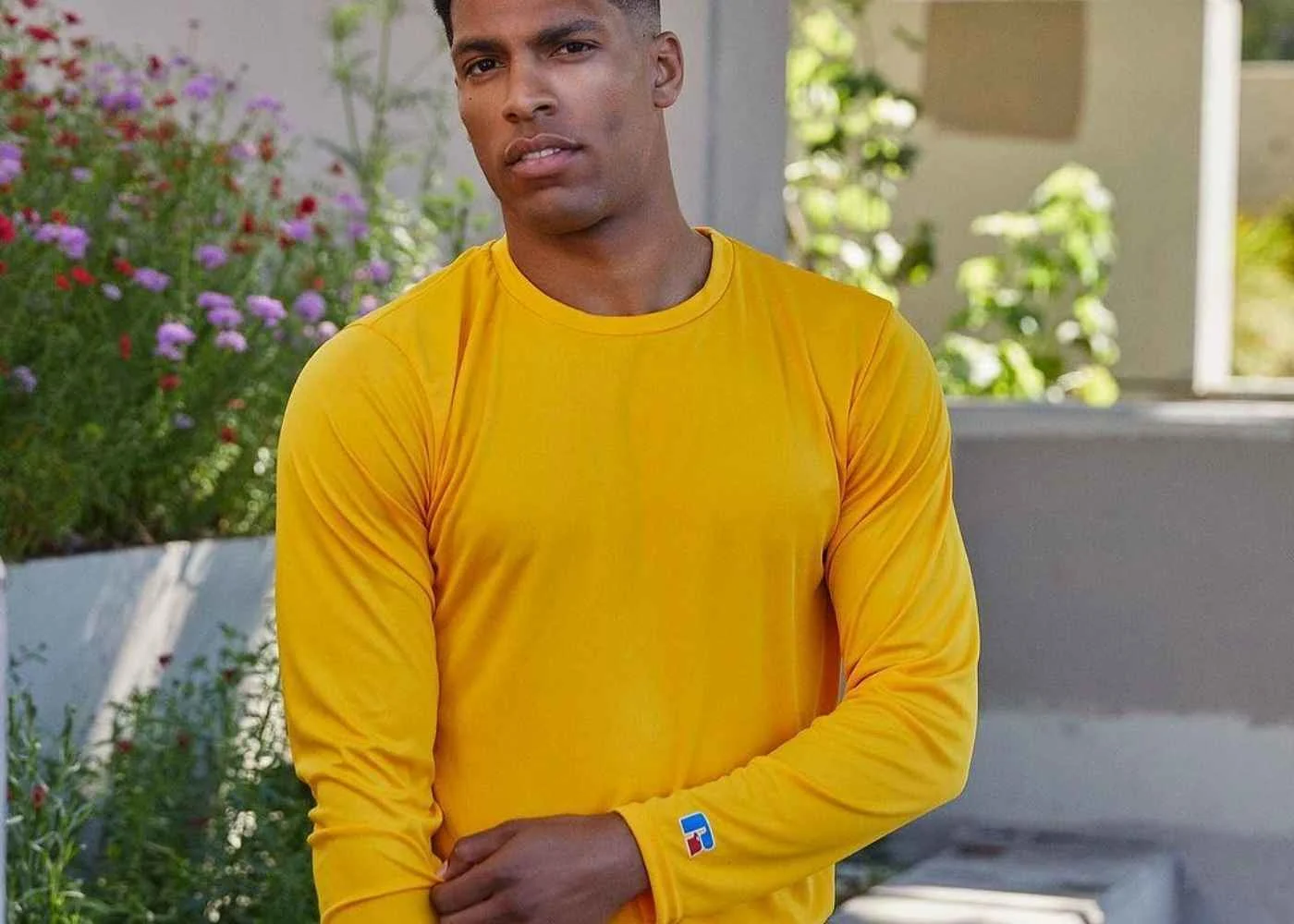 man wearing yellow long sleeve dri-power performance shirt outside