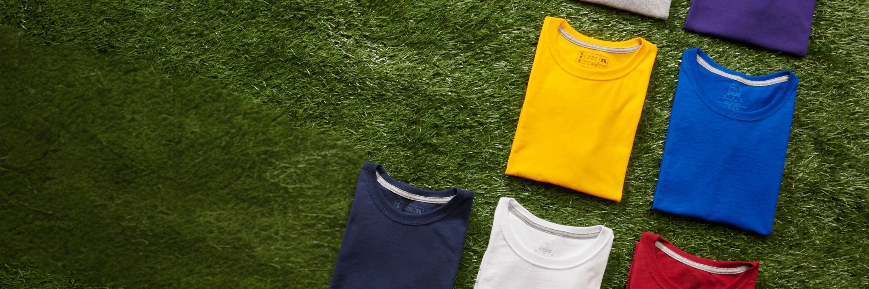 layflat of various colors of russell athletic shirts folded