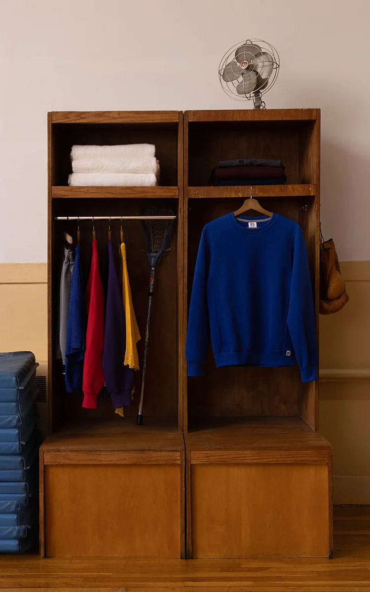 wooden cubby in gym showcasing hanging russell athletic product