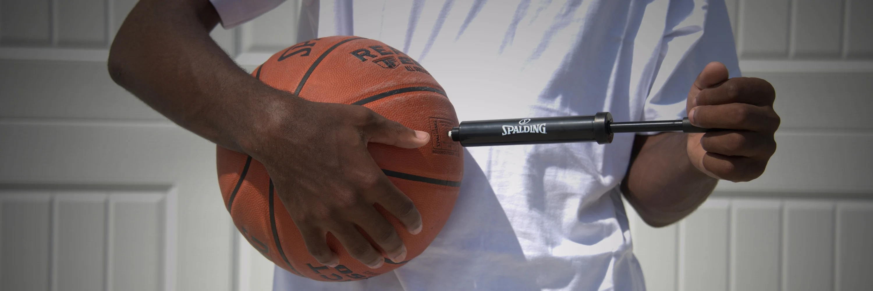 image of man inflating basketball