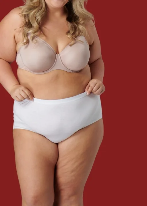 Woman wearing Fit For Me white briefs and tan bra.