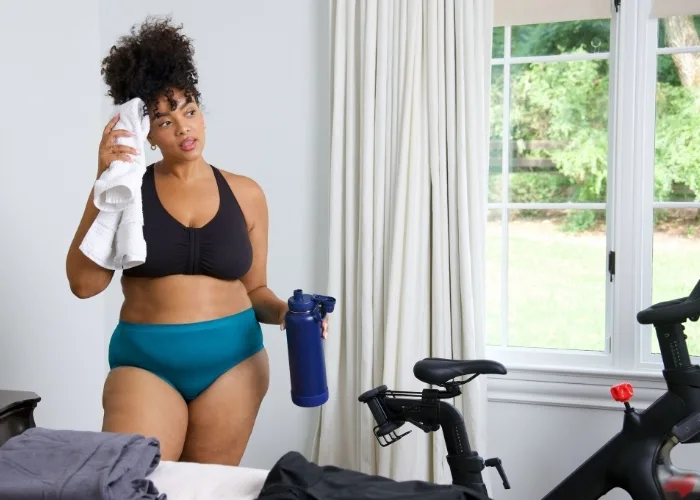 Women wiping her forehead after working out.